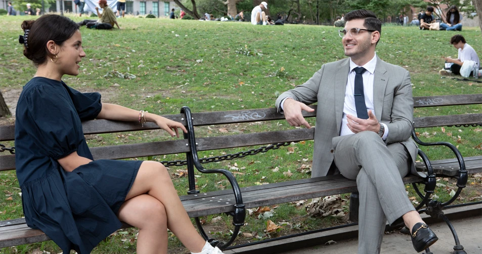 Dr. Paul Poulakos with Patient sitting on a bench outside